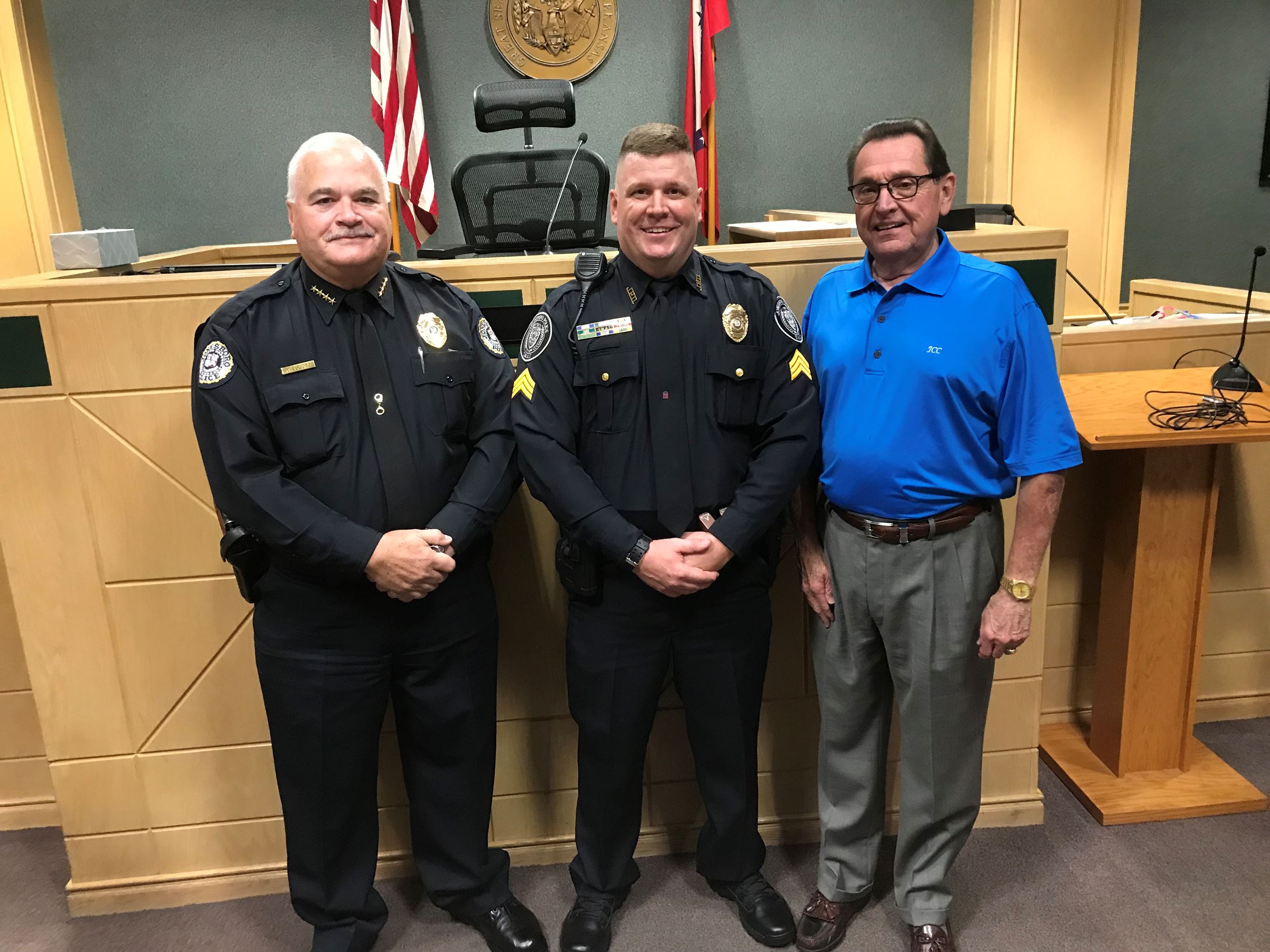 Jonesboro Police Department Officer Jason Chester, newly promoted to Sergeant, stands with Mayor Har