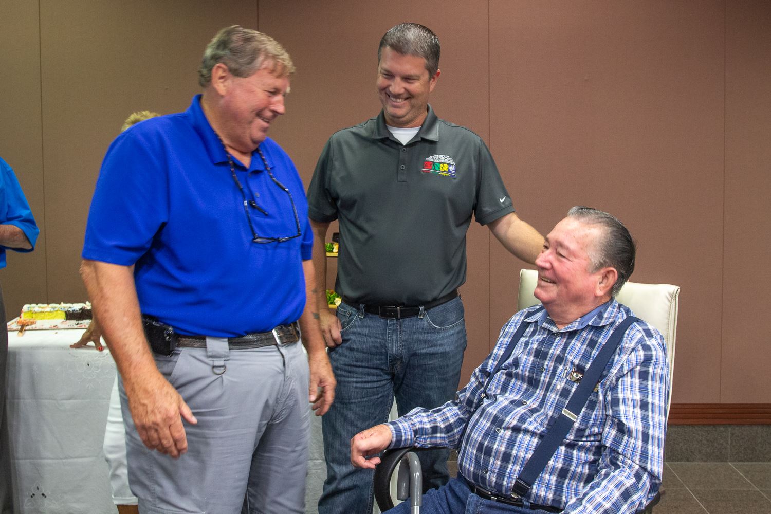 Building Maintence Director Ronnie Shaver and Parks Director Danny Kapales congratulate Paul Weaver 