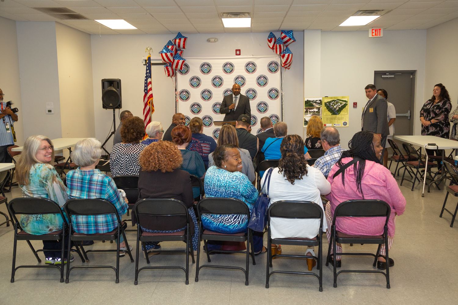 Veterans and attendees listen to a speaker.