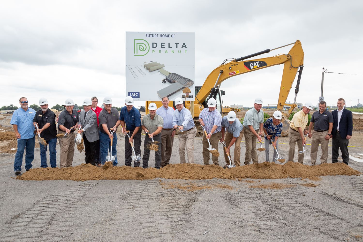 Officials including Mayor Perrin break ground with shovels for Delta Peanut.