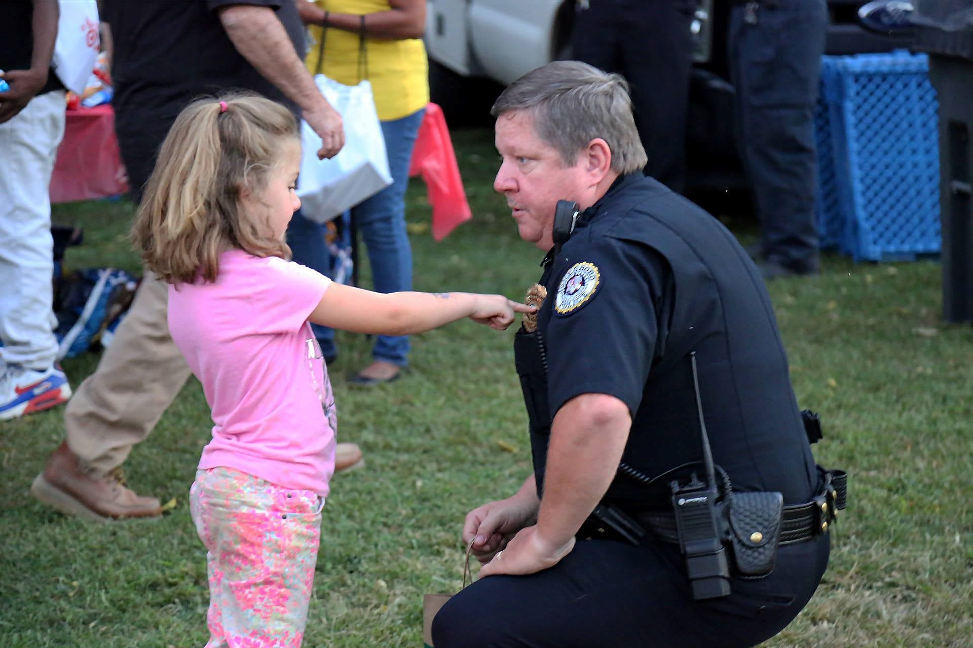 A police officer talks to a child during National Night Out
