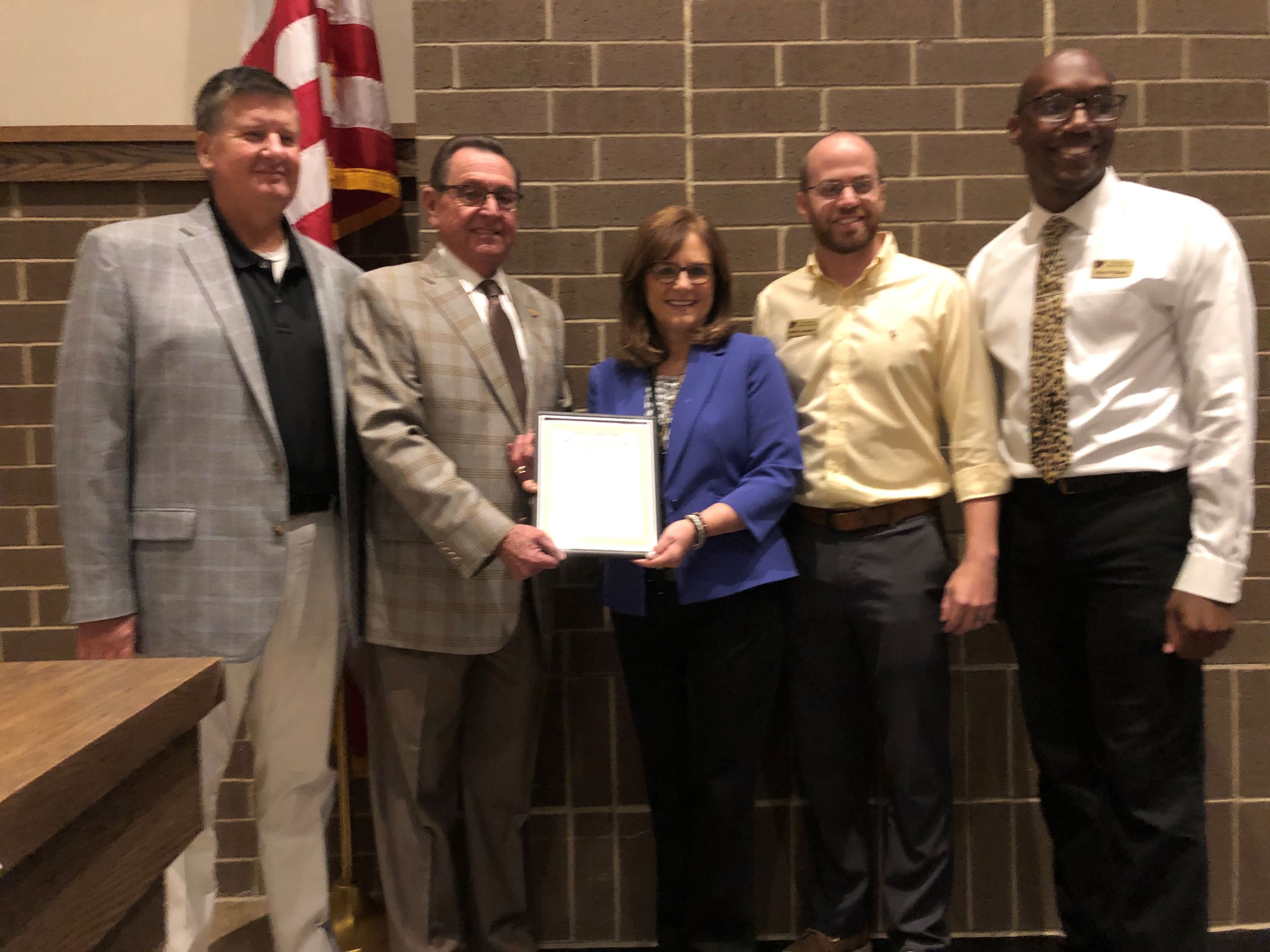 Mayor Perrin with school officials holding the proclamation.
