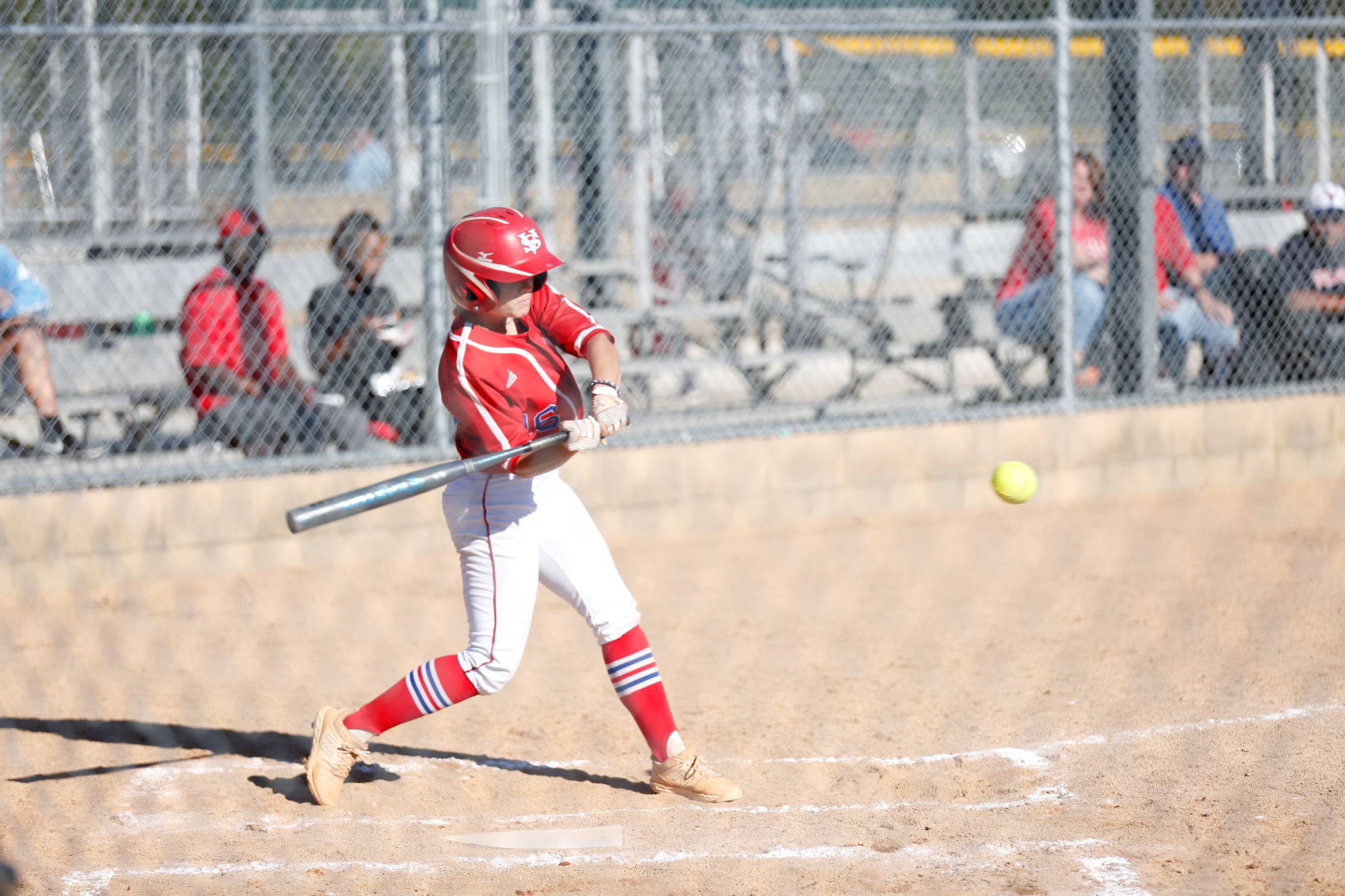 Softball player swings at ball at Southside Softball Complex.