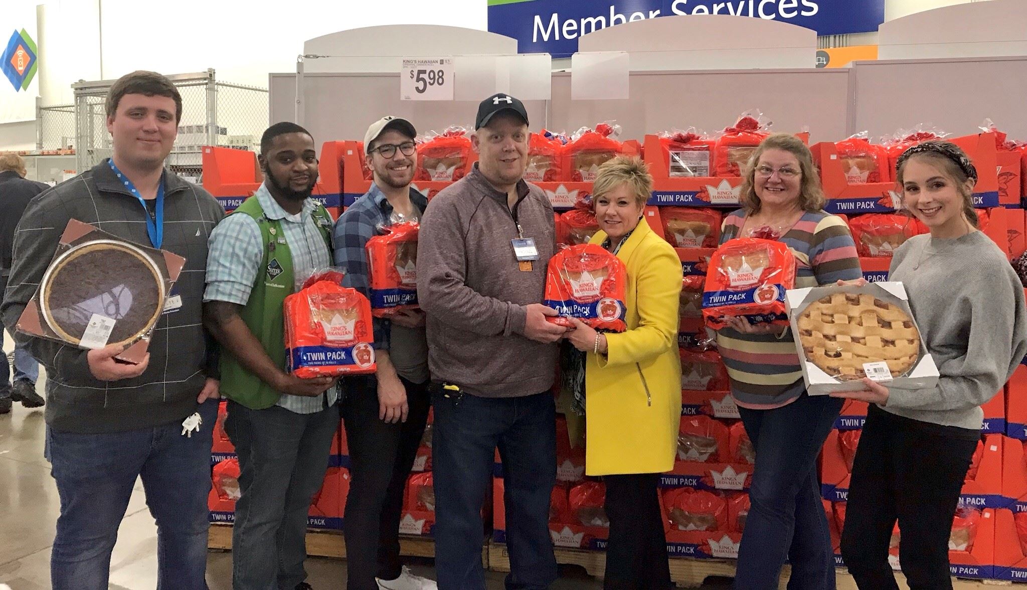 City Employees of the Grants Department stand with Sam's Club employees holding donated food