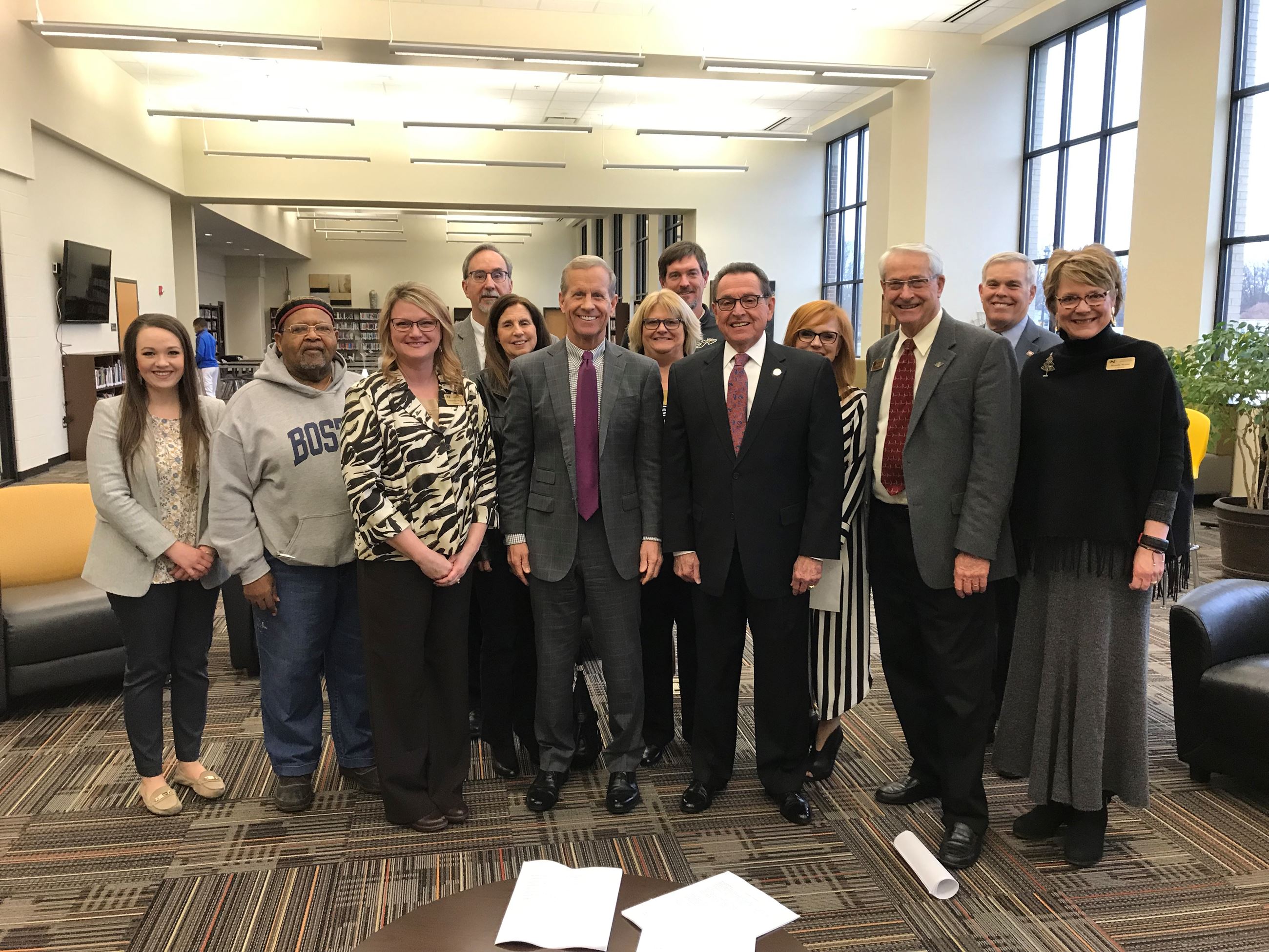 A group of officials along with Mayor Perrin pose with U.S. Assistant Secretary for Elementary and S