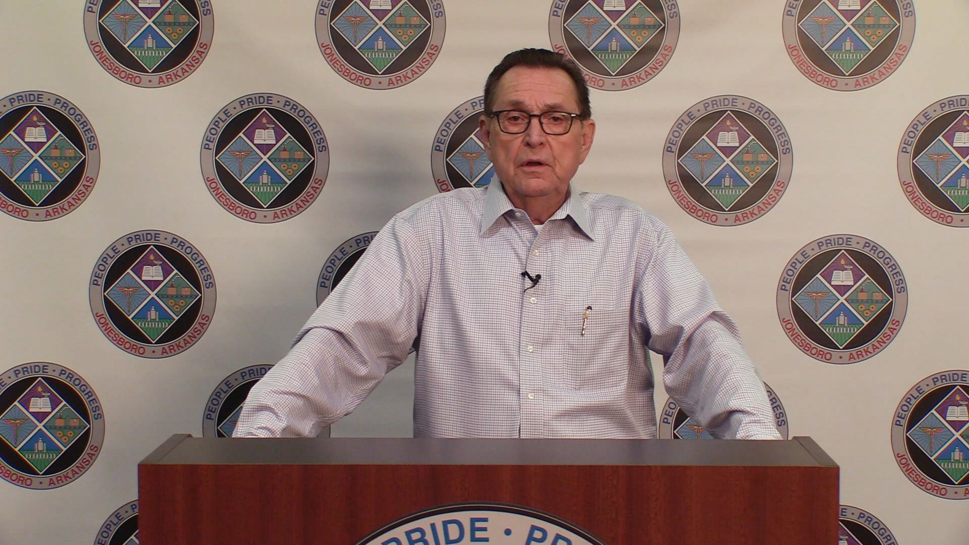 Mayor Perrin at a podium speaking to the camera giving his update