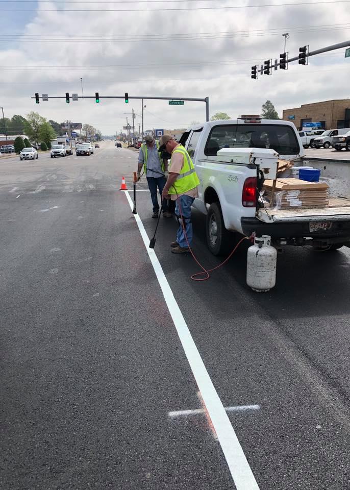 Street workers striping Nettleton Avenue