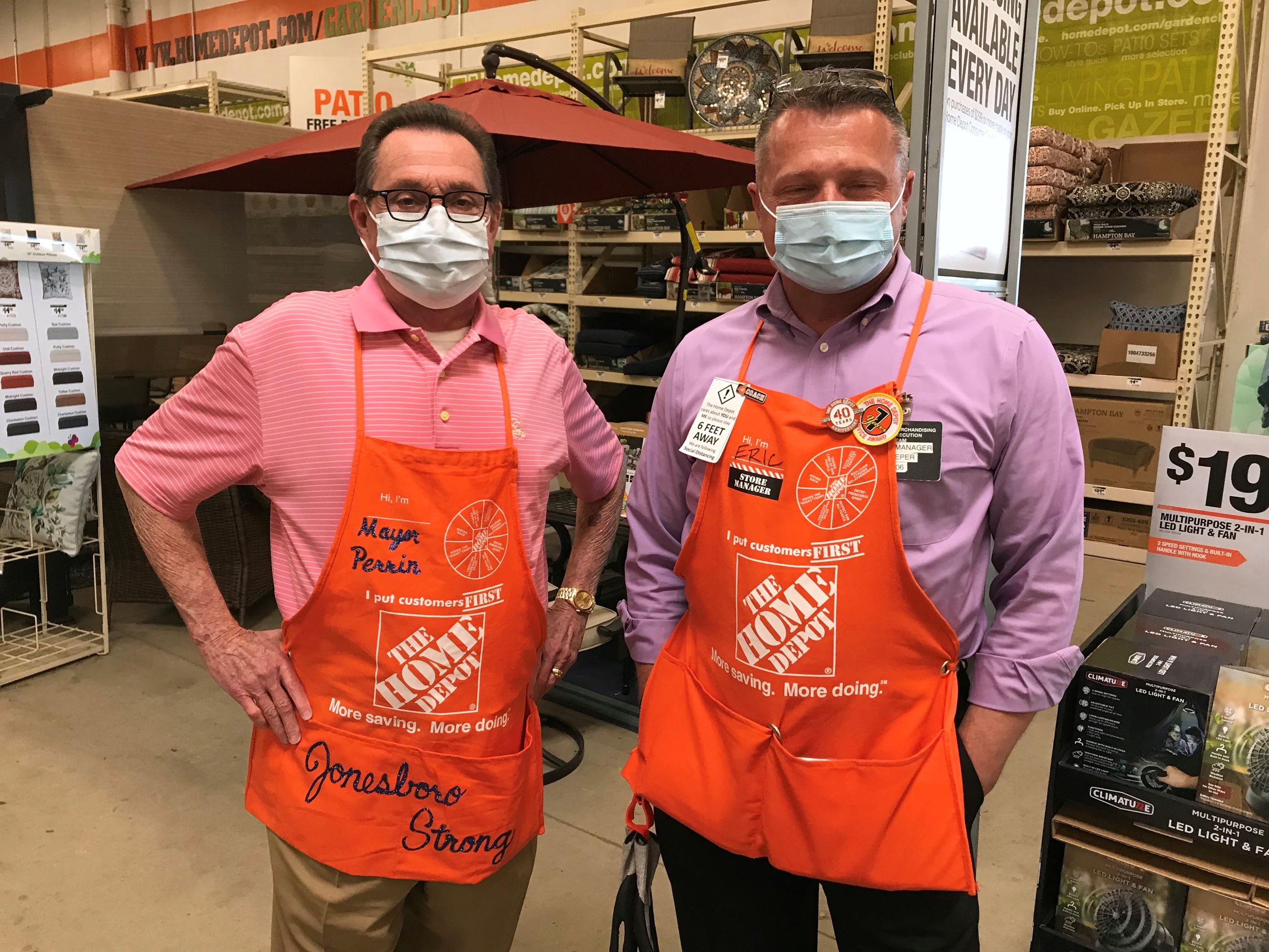 Mayor Perrin and Home Depot Manager Eric Pieper with masks and orange aprons on
