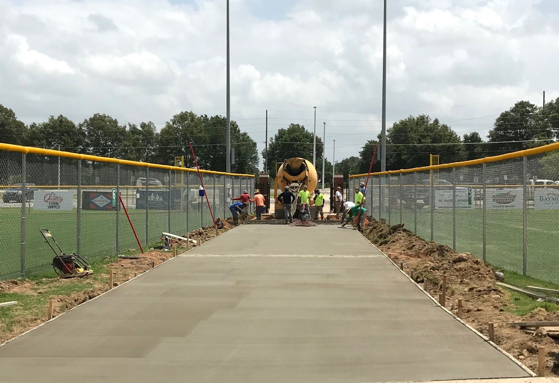 Workers pouring and smoothing concrete at Southside Softball Complex  