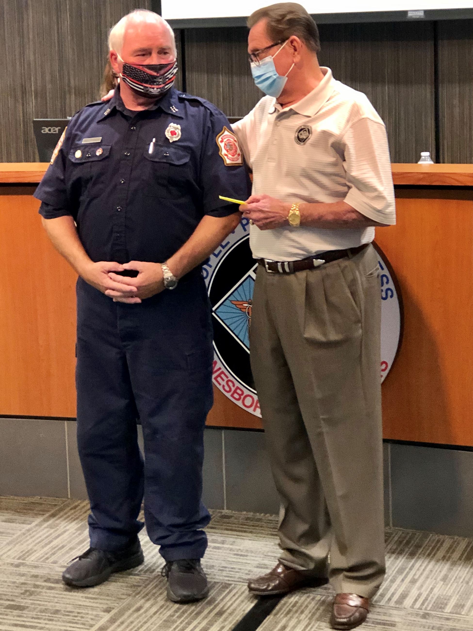 Mayor Perrin giving Captain Finley his 40-Year Service Pin