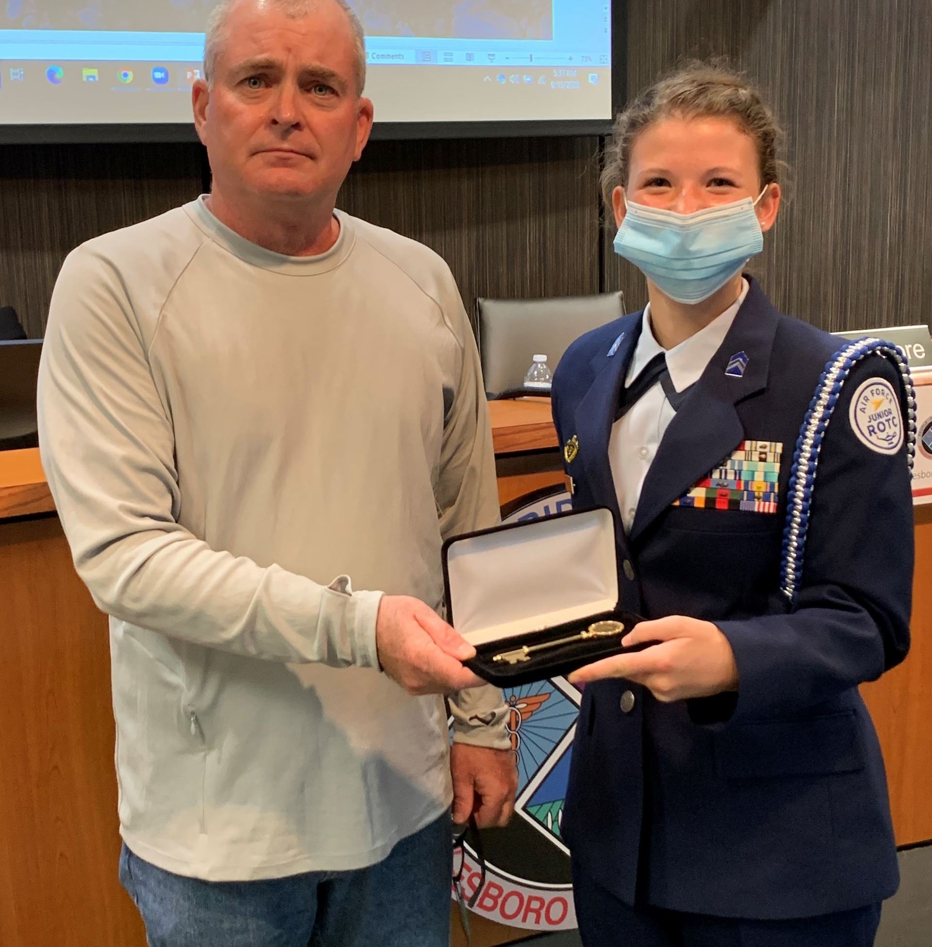 Cadet Laityn Tippy with Councilman Chris Moore holding Key to the City