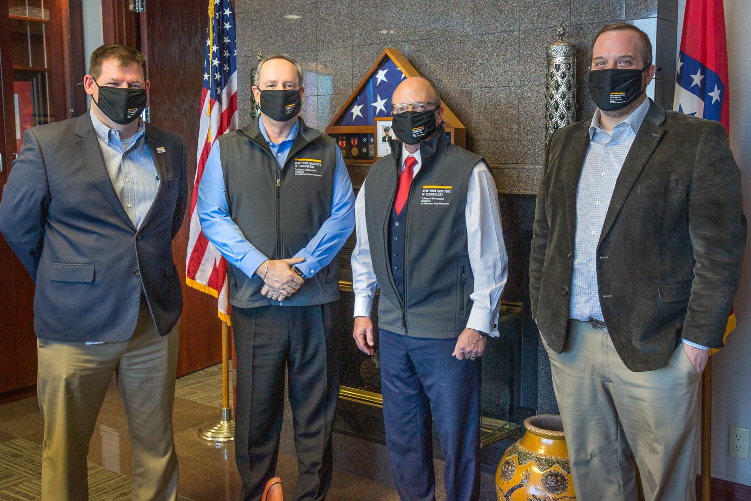 Casey Pearce, Bill Campbell, Mayor Copenhaver, and Brian Richardson wearing NYIT vests