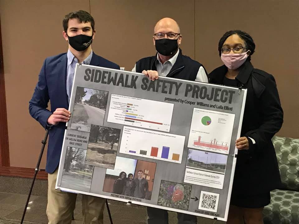 Mayor Copenhaver with Laila Eliotti and Cooper Williams holding their Sidewalk Safety project board