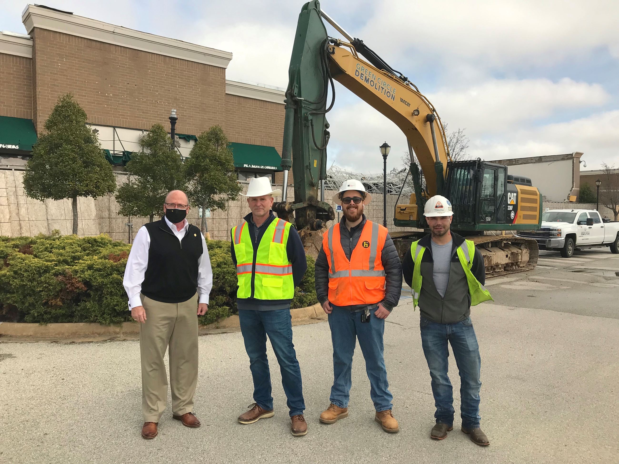 Mayor Copenhaver with Turtle Creek Mall Manager and Demolition Crew in front of mall with track hoe