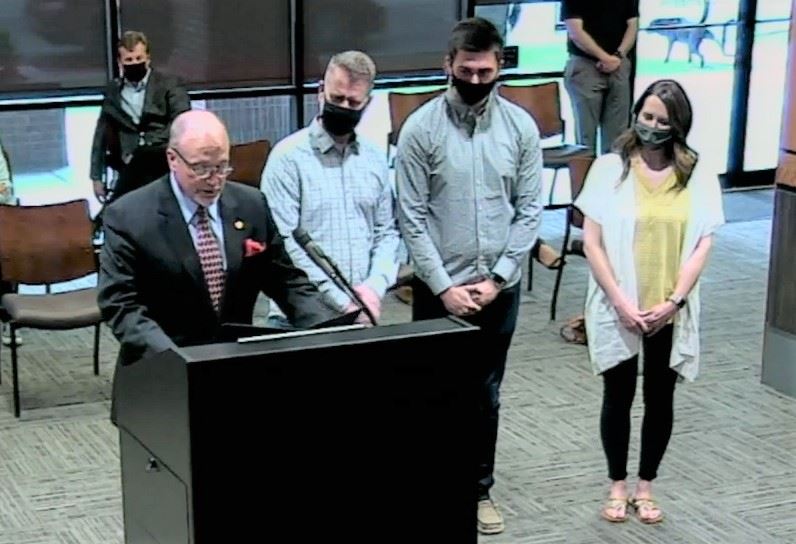 Mayor Copenhaver reading proclamation to audience and City Council with Benjamin Stewart next to him