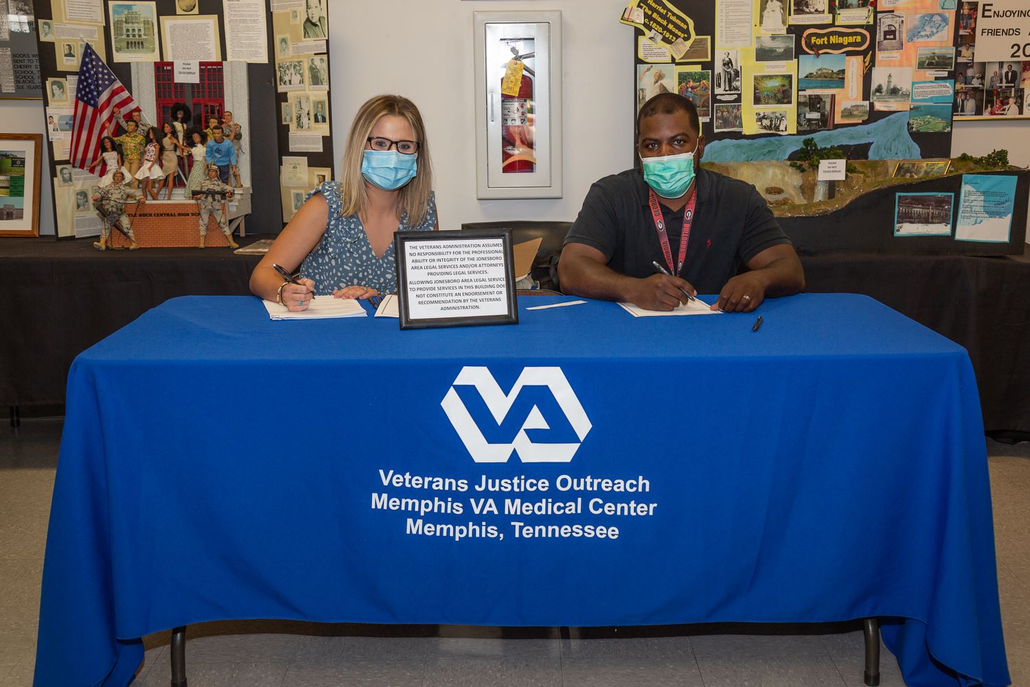Volunteers at the front help desk where veterans sign in