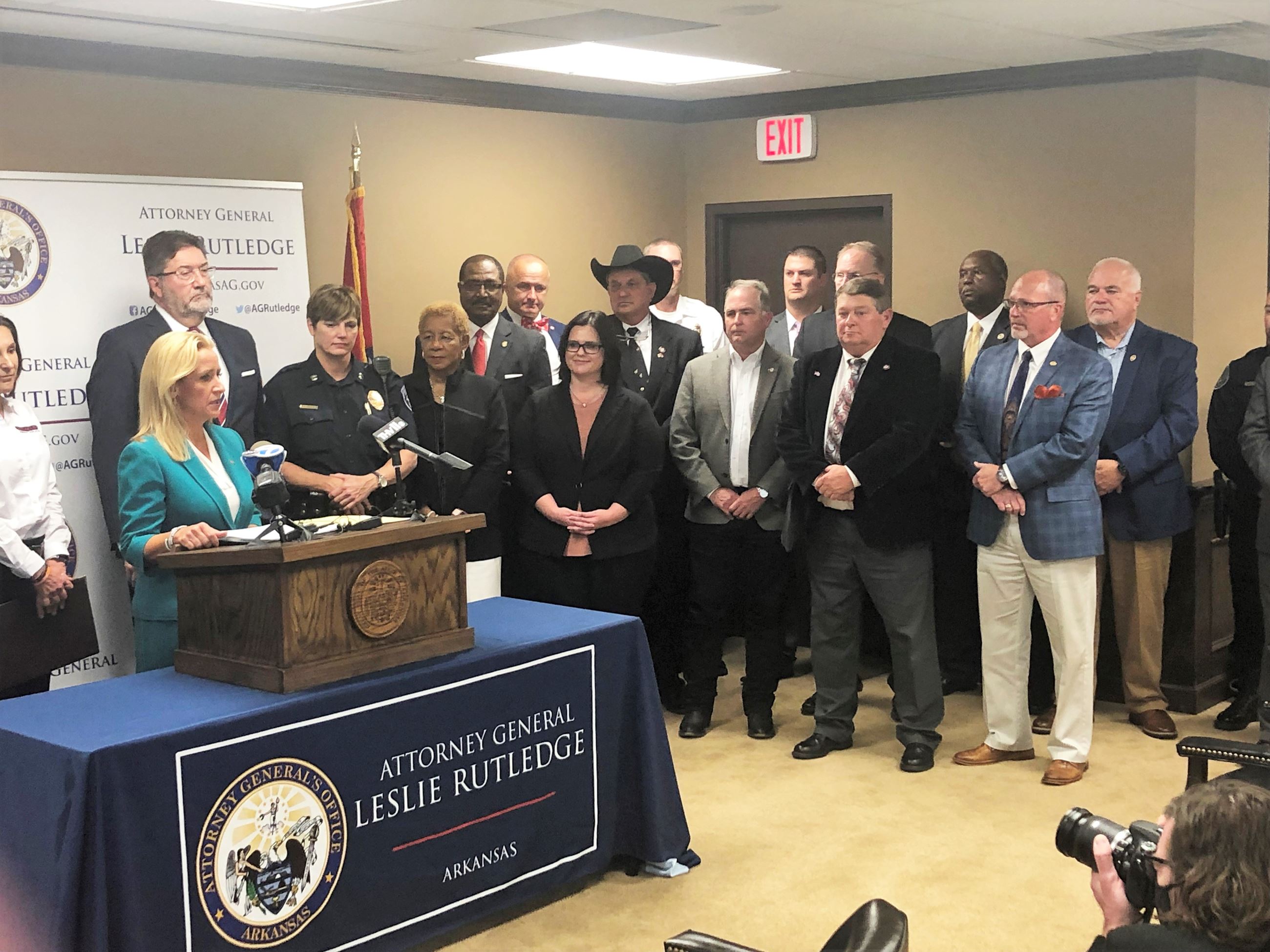 Attorney General Leslie Rutledge at podium announcing news  