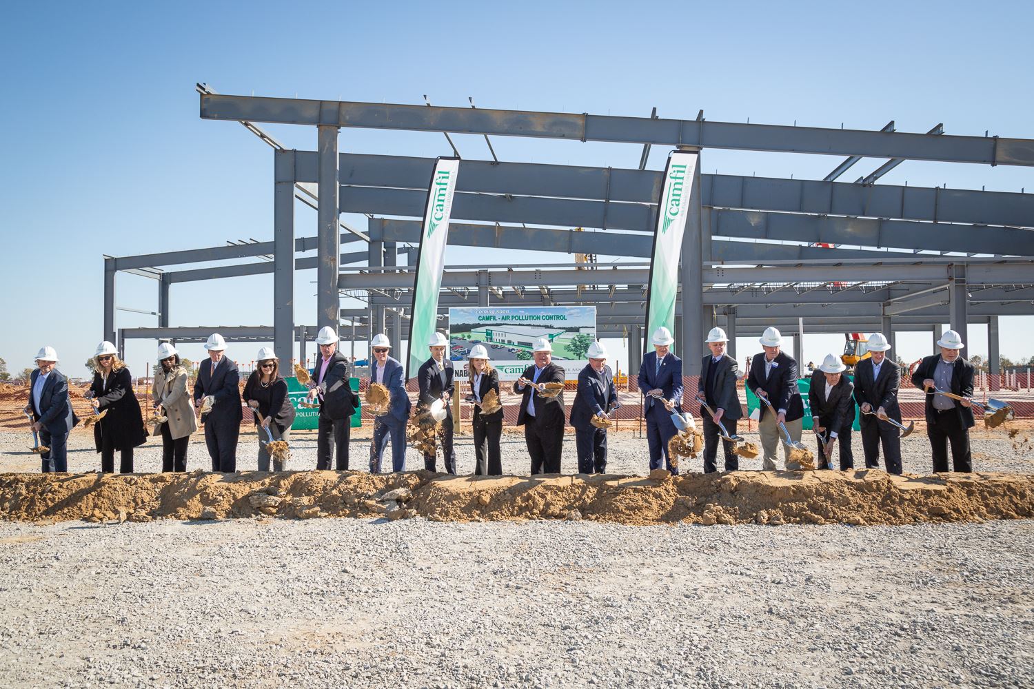 Leaders breaking ground with shovels on new factory