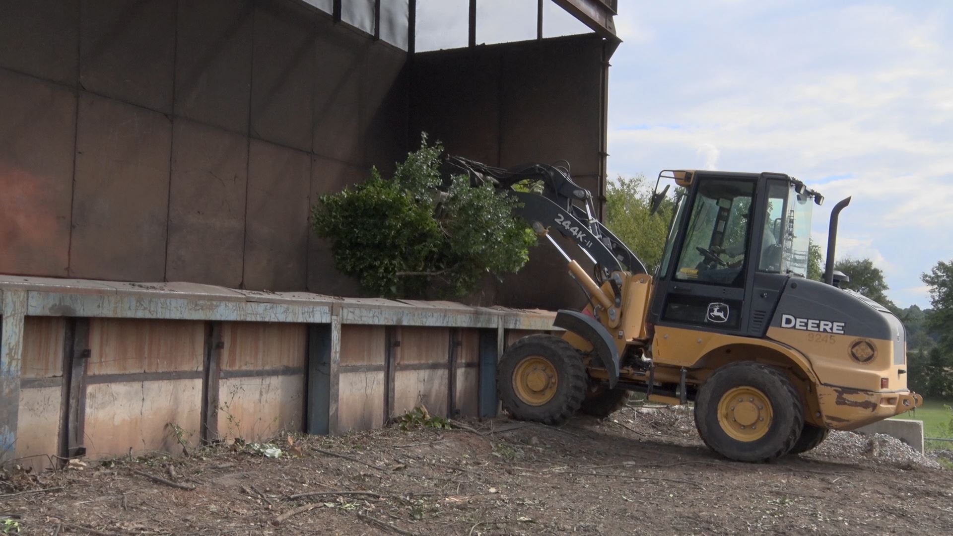 Front end loader putting tree limbs in incinerator
