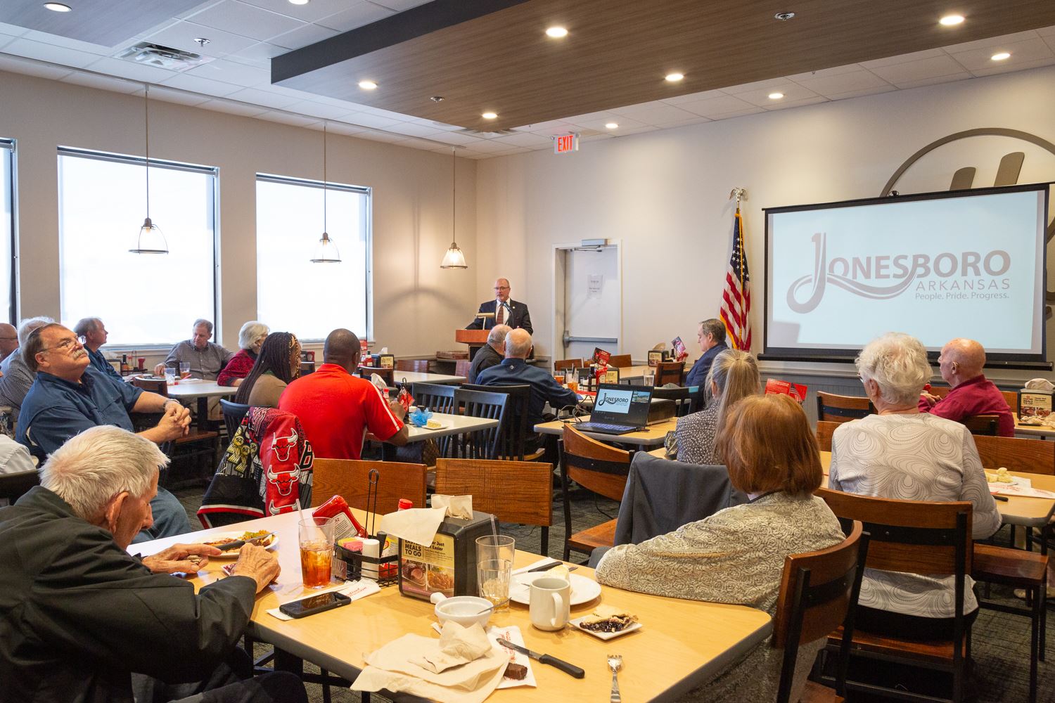 Mayor Copenhaver delivering presentation to crowded room of people