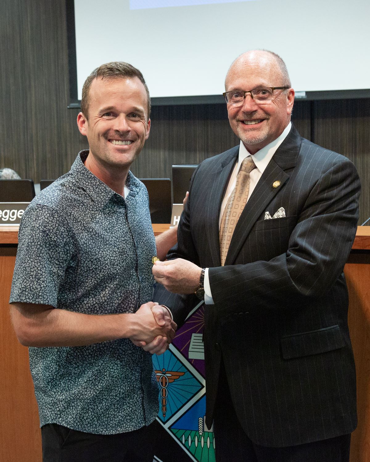 LJ Bryant and Mayor Copenhaver shaking hands and receiving service pin