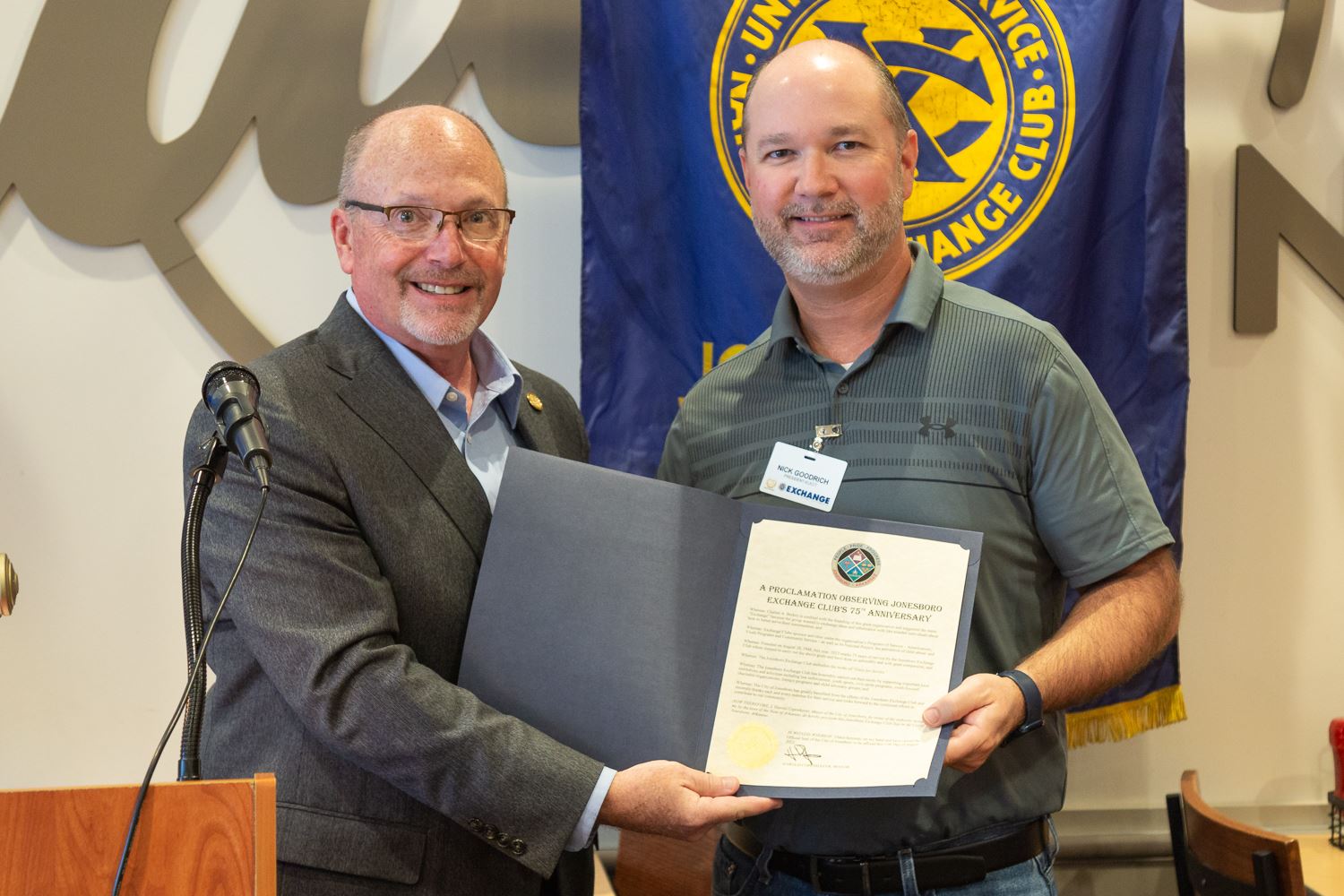 Mayor Copenhaver with Exchange Member and holding proclamation between the two of them