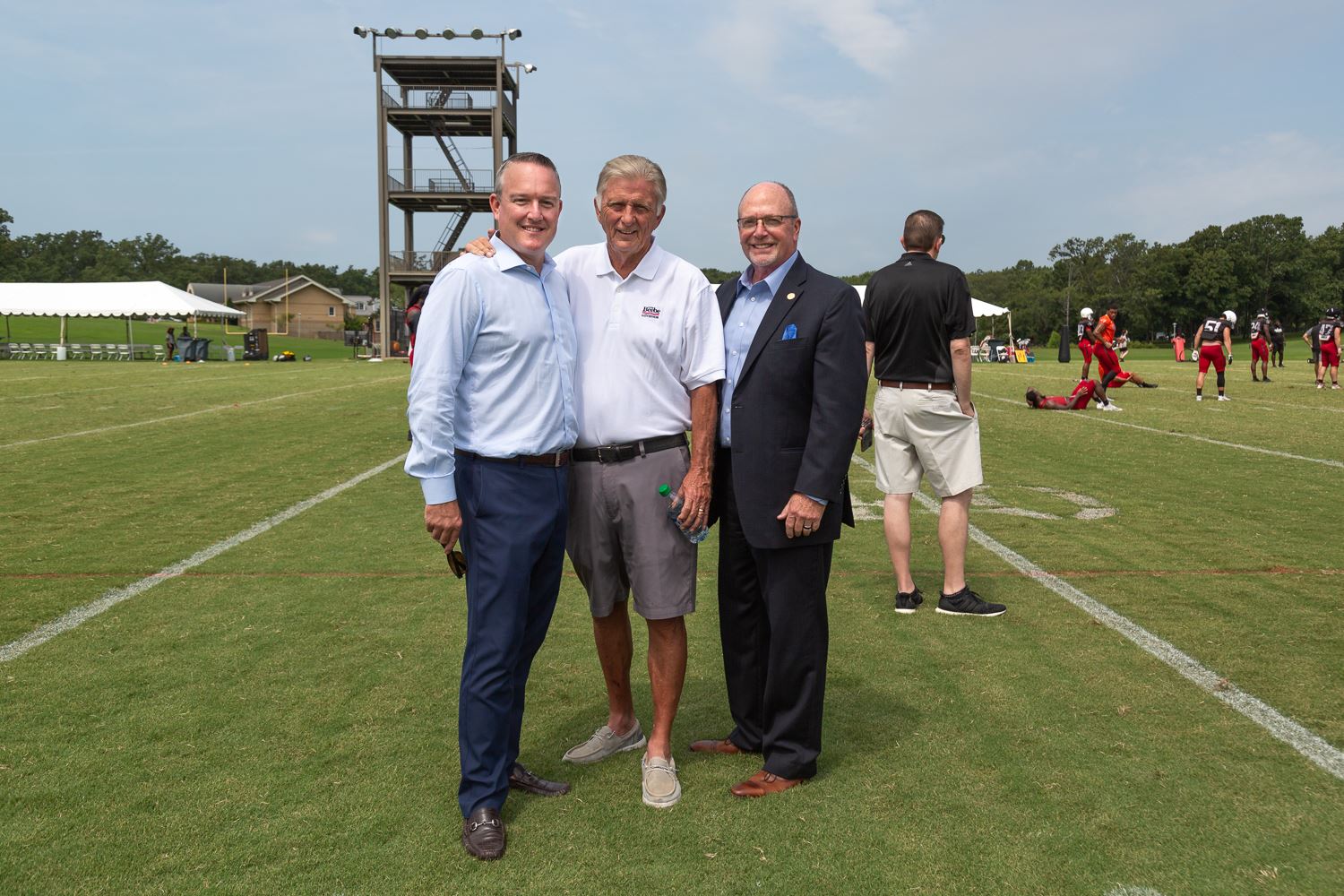 Athletic Director Jeff Purinton, former governor Mike Beebe, and Mayor Copenhaver