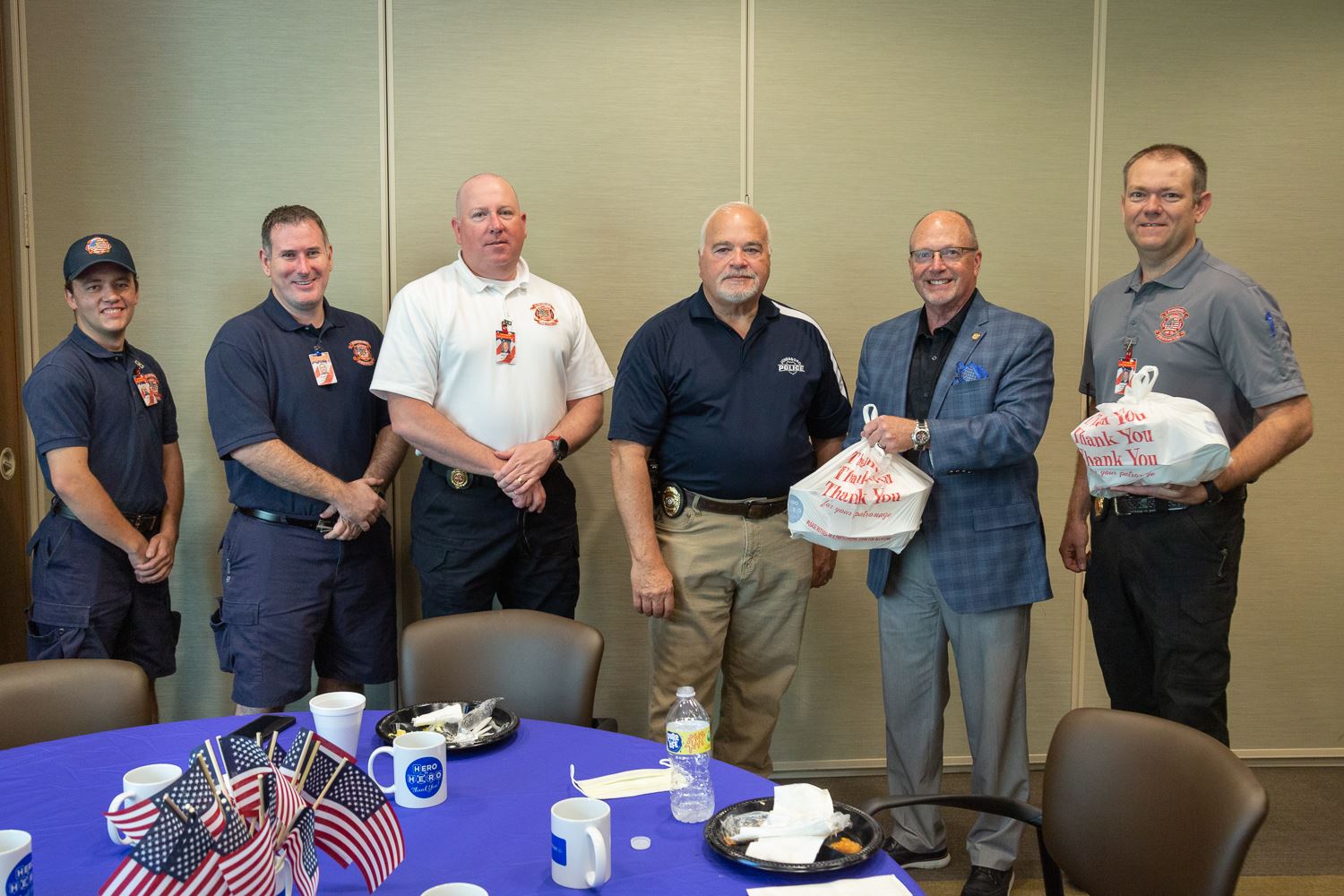 Mayor Copenhaver, Chief Hamrick, and Chief Elliott with firemen holding plates of food