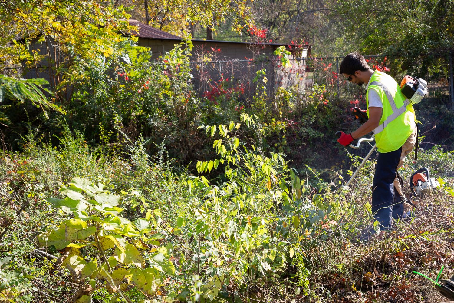 Breaking Bonds Ministries worker mowing ditch
