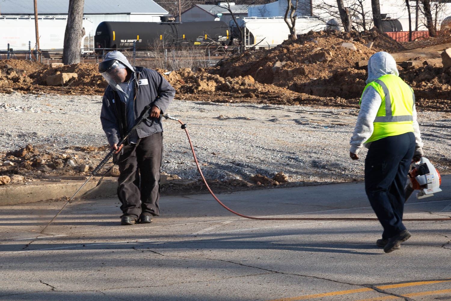 Street workers filling cracks in the street