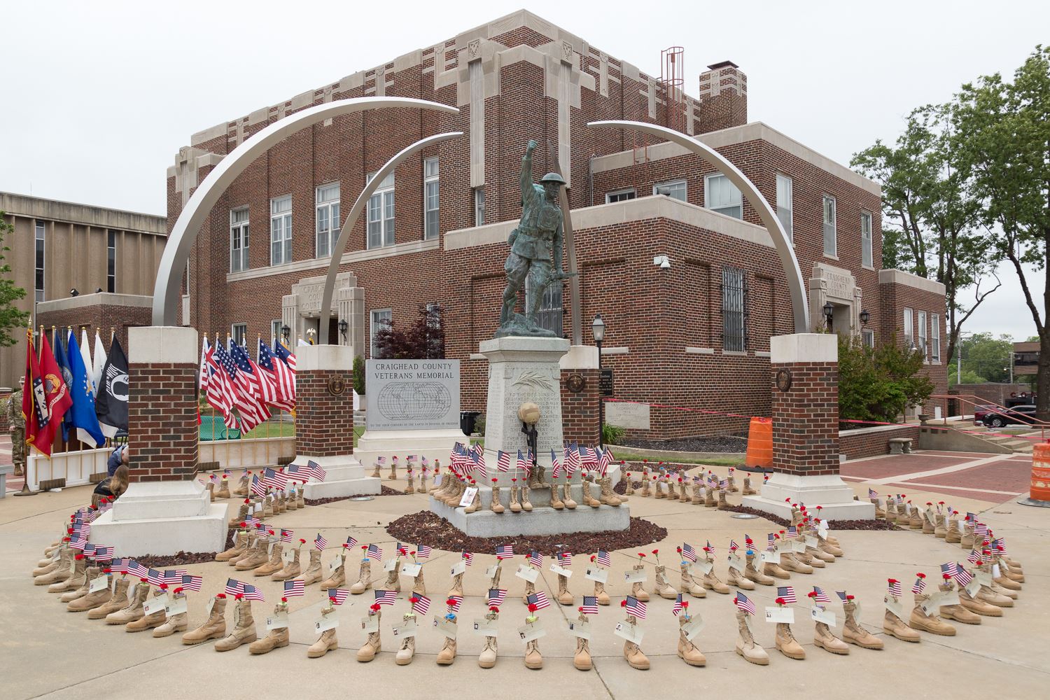 Veterans Memorial at Craighead County Courthouse covered with combat boots in a round circle