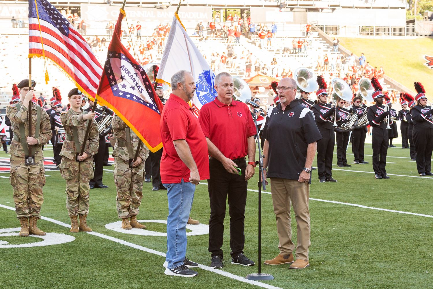 Mayor Copenhaver singing in trio at the A-State football game