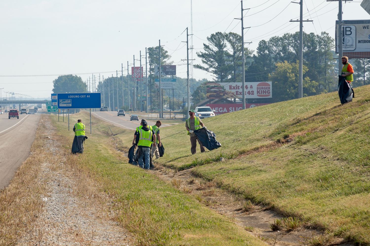 Members of Breaking Bonds Ministries picking up litter along I-555 expressway.