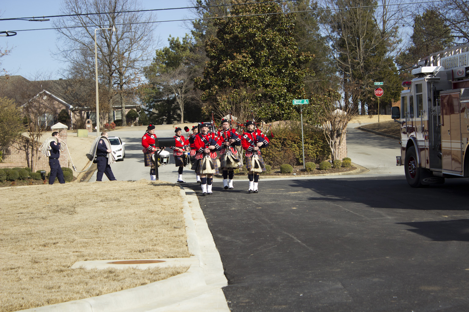 Jonesboro Firefighters Pipe Band marching together while playing bagpipes